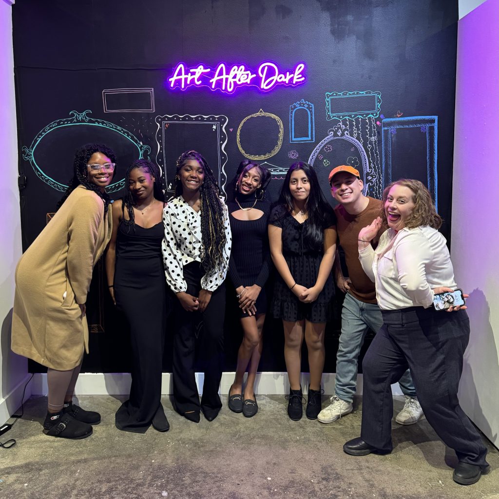 Group photo in front of Art After Dark Sign